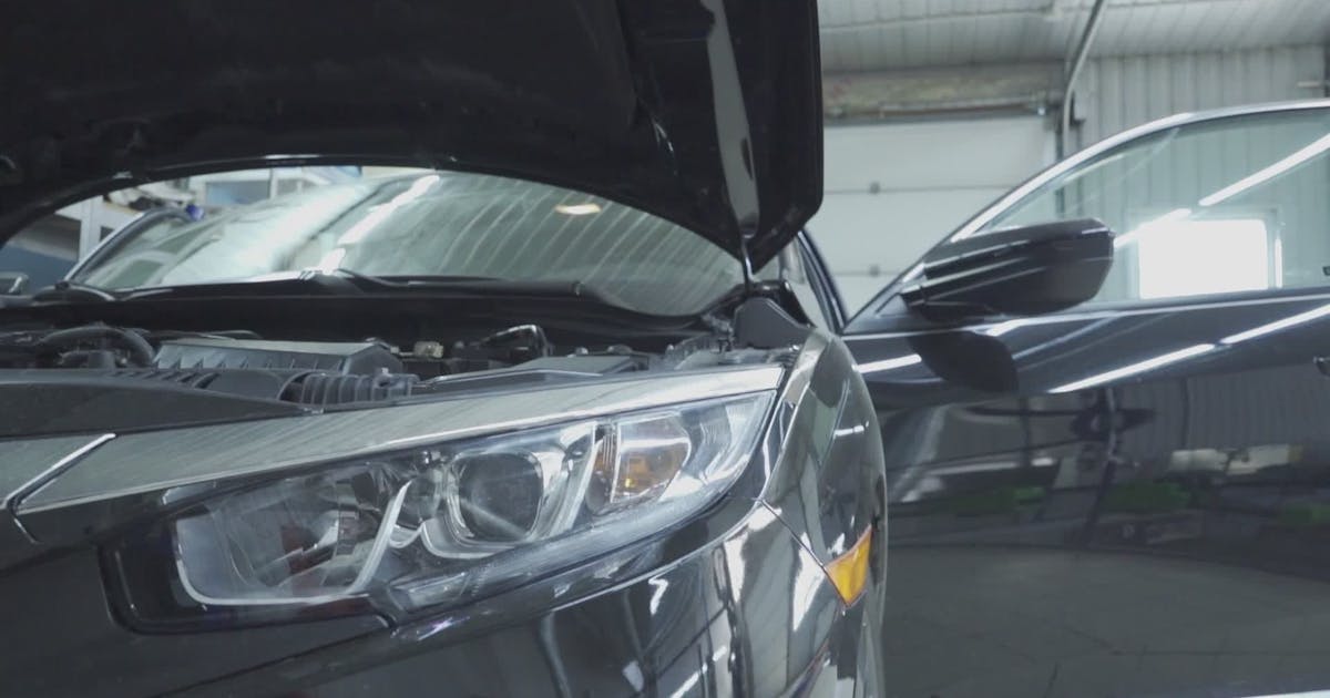 Car in a workshop with its hood open